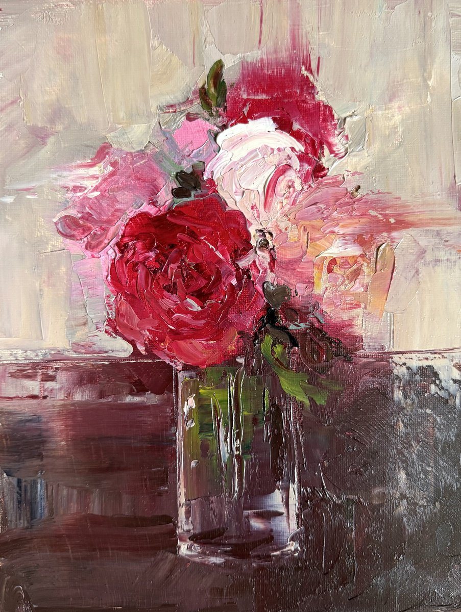 Oil painting of crimson and pink roses in a glass vase.