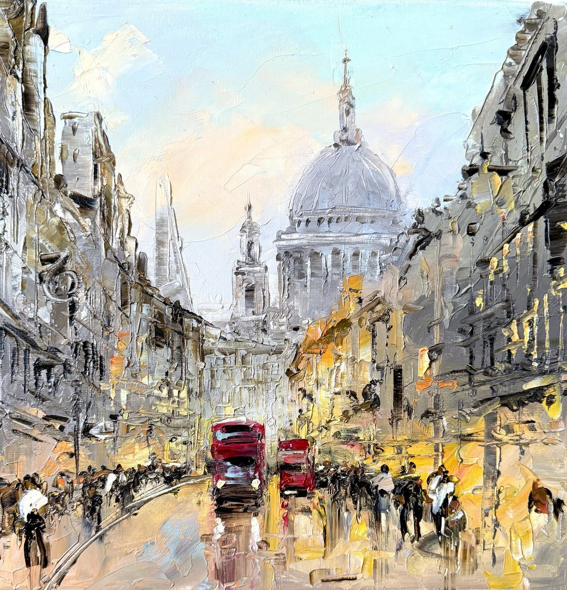 Oil painting of St. Paul&rsquo;s Cathedral at the end of a busy London street at evening, with red buses and glowing shopfronts.